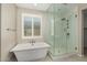 Bathroom featuring a freestanding tub and a glass enclosed shower at 3948 E Caitlin Dr, San Tan Valley, AZ 85140