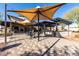 Community patio with multiple tables, chairs, bar area, and outdoor lighting at 3948 E Caitlin Dr, San Tan Valley, AZ 85140