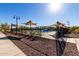 View of the community pool area with sunshades and plenty of lounge chairs at 3948 E Caitlin Dr, San Tan Valley, AZ 85140