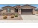 Lovely single-story home with a two car garage, desert landscaping and brick accents at 3948 E Caitlin Dr, San Tan Valley, AZ 85140