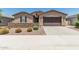 Charming single-story home features a stone accent wall, desert landscaping, and a two-car garage at 3948 E Caitlin Dr, San Tan Valley, AZ 85140