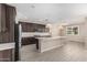 Modern kitchen with stainless steel appliances, dark cabinetry, a kitchen island, and elegant pendant lights at 3948 E Caitlin Dr, San Tan Valley, AZ 85140