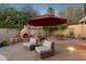 Outdoor living at it's finest: fireplace, stone patio, comfortable seating, & lush desert landscaping at 4146 N Lomond --, Mesa, AZ 85215