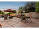 Entertain in style in this backyard oasis with stone patio, outdoor fireplace, and lush desert landscaping at 4146 N Lomond --, Mesa, AZ 85215
