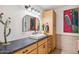 Bathroom features a large black countertop, decorative cactus, and a large mirror at 4146 N Lomond --, Mesa, AZ 85215