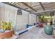 Charming courtyard with wooden pergola, mature cacti and colorful landscaping provides a peaceful outdoor escape at 4146 N Lomond --, Mesa, AZ 85215