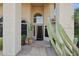 Inviting front entrance with flagstone walkway, arched windows, and lush desert landscaping at 4146 N Lomond --, Mesa, AZ 85215