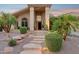 The desert-landscaped front yard has stone steps leading to the inviting covered porch of this home at 4146 N Lomond --, Mesa, AZ 85215