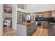 A full kitchen with stainless steel appliances and center island provides plenty of storage and workspace at 4146 N Lomond --, Mesa, AZ 85215