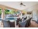 Covered patio with wicker seating, pool views, a television and an outdoor fireplace at 4146 N Lomond --, Mesa, AZ 85215