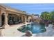 Backyard pool features a rock waterfall, built-in BBQ and a covered patio with seating at 4146 N Lomond --, Mesa, AZ 85215