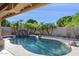 Backyard pool with mature landscaping, rock waterfall and covered patio with BBQ at 4146 N Lomond --, Mesa, AZ 85215
