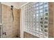 Shower features glass blocks for natural light and a handheld shower head; neutral tile throughout at 4146 N Lomond --, Mesa, AZ 85215