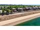 An aerial shot shows green canal water bordering properties with lush landscaping, fences, and a clear blue sky at 4379 E Rosemonte Dr, Phoenix, AZ 85050