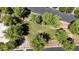An aerial shot shows the common area with mature trees, lush green grass, walking path, and manicured landscaping at 4379 E Rosemonte Dr, Phoenix, AZ 85050