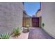 Side yard with brick pavers, small fire pit, desert landscaping and a security gate at 4379 E Rosemonte Dr, Phoenix, AZ 85050