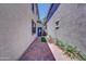 Side yard with brick pavers, desert landscaping and a blue back door at 4379 E Rosemonte Dr, Phoenix, AZ 85050