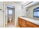 Bathroom featuring double sink vanity with a marble countertop, and access to the private shower at 4379 E Rosemonte Dr, Phoenix, AZ 85050