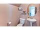 Charming powder room with a pedestal sink and a soft color palette creating a clean and inviting space for guests at 4379 E Rosemonte Dr, Phoenix, AZ 85050