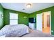 Bedroom with green walls, carpet, and a window for natural light at 4379 E Rosemonte Dr, Phoenix, AZ 85050