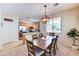 Comfortable dining room featuring a wooden table, pendant lighting, and adjacent kitchen space, ideal for Gathering meals at 4379 E Rosemonte Dr, Phoenix, AZ 85050