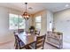 Inviting dining area filled with natural light, wood furniture, and neutral decor offering a warm and welcoming atmosphere at 4379 E Rosemonte Dr, Phoenix, AZ 85050