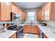 Contemporary kitchen featuring granite countertops, stainless steel appliances, and a view of the outdoors from the sink at 4379 E Rosemonte Dr, Phoenix, AZ 85050