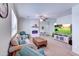 Comfortable living room with plush seating, electric fireplace and mounted TV, ideal for relaxation and entertainment at 4379 E Rosemonte Dr, Phoenix, AZ 85050