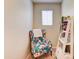 Cozy sitting area featuring a floral accent chair and natural light at 4379 E Rosemonte Dr, Phoenix, AZ 85050