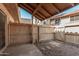 Backyard with covered patio area and gravel landscaping, enclosed by a wooden fence at 4601 N 102Nd Ave # 1178, Phoenix, AZ 85037