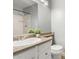Bathroom featuring a white vanity, stone countertop, shower with tile surround, and a decorative plant at 4601 N 102Nd Ave # 1178, Phoenix, AZ 85037