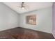 This bedroom has wood floors, ceiling fan, and a bright window at 4601 N 102Nd Ave # 1178, Phoenix, AZ 85037