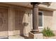 Close-up of front entry showcasing secure door, exterior lighting, and decorative pillar at 4601 N 102Nd Ave # 1178, Phoenix, AZ 85037