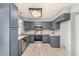 Updated kitchen features stainless steel appliances, granite countertops, and abundant blue cabinetry at 4601 N 102Nd Ave # 1178, Phoenix, AZ 85037