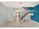 Open-concept living room with tile floors, staircase, and seamless flow to the kitchen at 4601 N 102Nd Ave # 1178, Phoenix, AZ 85037