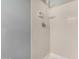 Tiled shower area featuring white tiles, a shower head, and a soap dish at 4601 N 102Nd Ave # 1178, Phoenix, AZ 85037