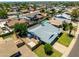 Aerial shot showcases the home with a fenced yard, mature trees, and a serene neighborhood setting at 5751 W Muriel Dr, Glendale, AZ 85308