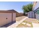 This backyard features gravel landscaping, a brick paver walkway, and two storage sheds for gardening and tools at 5751 W Muriel Dr, Glendale, AZ 85308