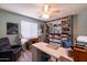 Spacious bedroom with a ceiling fan, laminate floors, and lots of built-in storage at 5751 W Muriel Dr, Glendale, AZ 85308