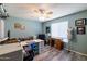Spacious bedroom with a ceiling fan, laminate floors, a work space, and nice decorations at 5751 W Muriel Dr, Glendale, AZ 85308