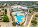 Overhead view of a modern community recreation center with a pool, diving boards, slides, and shaded seating at 5751 W Muriel Dr, Glendale, AZ 85308