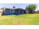 The home's exterior boasts a covered patio, green lawn, mature tree, and neutral color scheme at 5751 W Muriel Dr, Glendale, AZ 85308