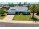 Charming single-story home featuring mature landscaping, a spacious front yard, and a two-car garage at 5751 W Muriel Dr, Glendale, AZ 85308
