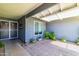 Inviting front porch area with tiled flooring and neutral gray walls offers a charming welcome to the home at 5751 W Muriel Dr, Glendale, AZ 85308