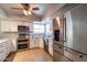 Well-equipped kitchen with stainless steel appliances, granite countertops, and ample cabinet space at 5751 W Muriel Dr, Glendale, AZ 85308