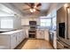 Modern kitchen design featuring white cabinets, granite countertops, and updated stainless appliances at 5751 W Muriel Dr, Glendale, AZ 85308