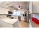 Bright kitchen showcasing stainless steel appliances, white cabinetry, and granite countertops at 5751 W Muriel Dr, Glendale, AZ 85308
