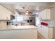 Modern kitchen featuring white cabinets, granite countertops, and stainless steel appliances at 5751 W Muriel Dr, Glendale, AZ 85308