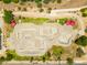 Aerial view of a skate park with concrete bowls and shaded seating, perfect for skateboarders and community gatherings at 5751 W Muriel Dr, Glendale, AZ 85308