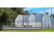 Outdoor tennis court with fencing and lighting for evening play at 5751 W Muriel Dr, Glendale, AZ 85308